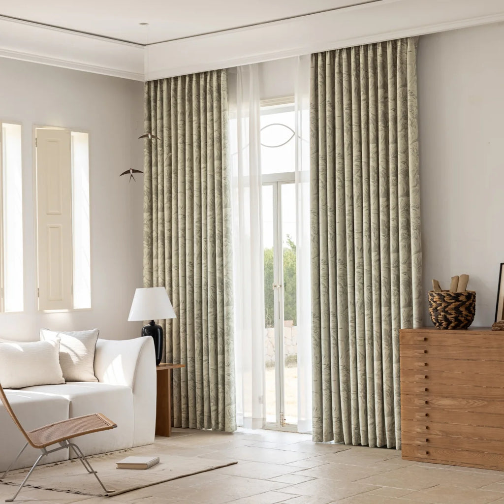 Sage jacquard blackout curtains dressing tall doors in a warm living room