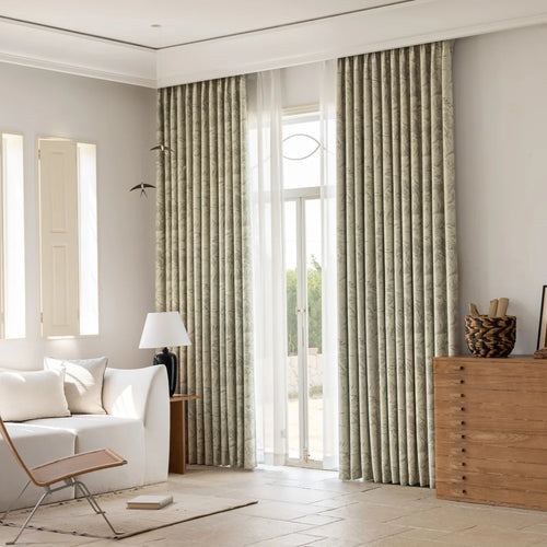 Sage jacquard blackout curtains dressing tall doors in a warm living room