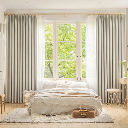 Greige herringbone curtains with sheer layer in a calm bedroom