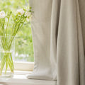 Herringbone chenille curtain in greige beside cut flowers