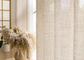 Oatmeal linen-look voile curtain diffusing warm window light