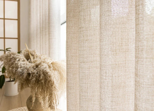 Oatmeal linen-look voile curtain diffusing warm window light