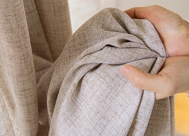 Slubbed weave of the oatmeal voile held in hand